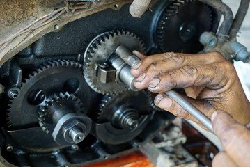 repairman hands fixing on engine at a repair service