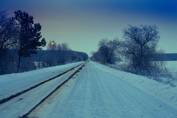 Winter snowy road at sunrise