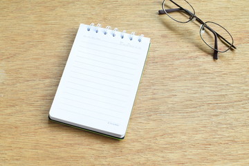 White notebook on wooden background