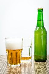  beer in the glass and covers on wooden table