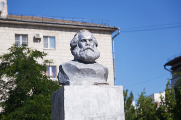 Obraz premium Бюст Карл Маркс во дворе дома на фоне синего неба. Волгоград, Россия