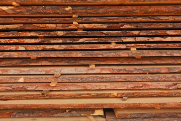 Stacked of wood log for construction buildings background and texture