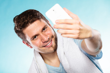 Happy half shaved man taking selfie self photo.