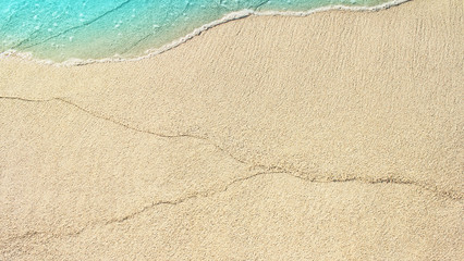 Soft ocean wave on the sandy beach