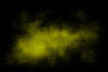 Yellow abstract powder explosion on a black background