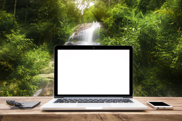 Laptop with blank screen on table wood Waterfall beautiful.