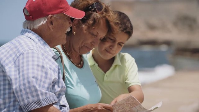 Happy tourists on holidays, during vacation journey. Hispanic people traveling in Havana, Cuba. Grandpa, grandma and grandson having fun near the sea. Family trip, elderly man, woman, child