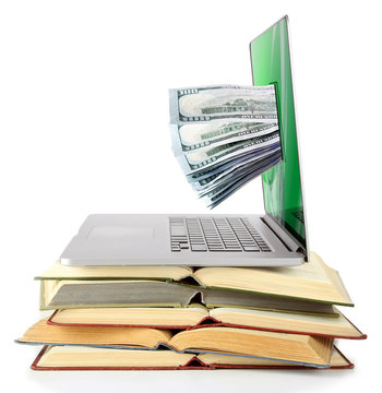 Stack of books and laptop with money from monitor screen isolated on white