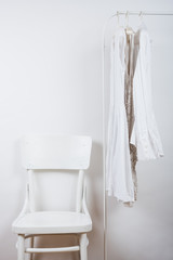 Obraz na płótnie Canvas bedroom white interior, clothes on the hanger 