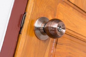 door knob and keyhole on wooden door