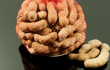 Tamarind sweet in net and black background