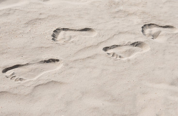 Fototapeta na wymiar Footprints in the sand, sea, human footprints in the sand on the beach.