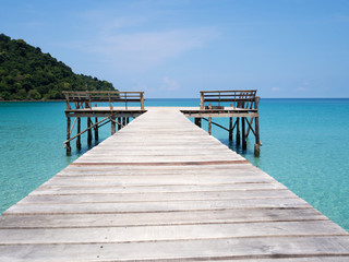Fototapeta premium Jetty into blue sea and sky. Pier over water. Vacation And tourism concept. Tropical resort. Jetty on Koh Kood Island, Thailand.