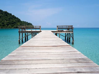 Fotobehang Jetty into blue sea and sky. Pier over water. Vacation And tourism concept. Tropical resort. Jetty on Koh Kood Island, Thailand. © ieang