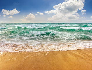 sea ​​waves running on sandy beach