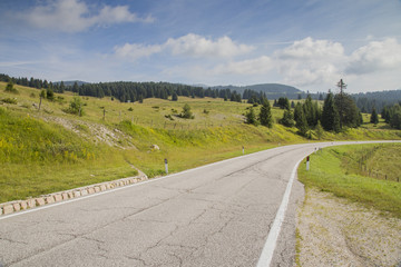 Road along a mountain landscape. Italian Alps.