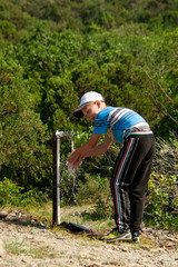 boy washes his hands in nature