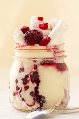 Ice cream in a glass jar with some berries