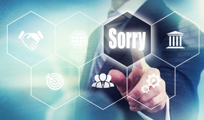 Businessman pushing a sorry concept button.
