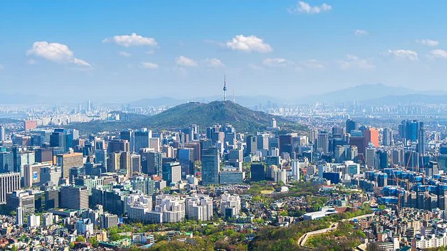 Time lapse of Cityscape in Seoul with Seoul tower and blue sky, South Korea.