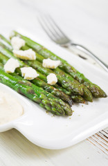 Grilled asparagus with sauce and cheese