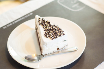 White chocolate cake in white plate at cofee shop