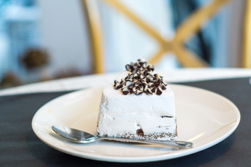 White chocolate cake in white plate at cofee shop