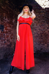 fashionable woman in red dress and black hat