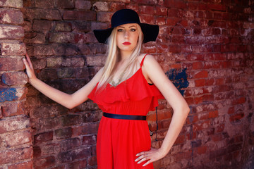 fashionable woman in red dress and black hat