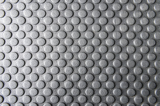 The rubber mats,the rubber mats with the round pattern texture for anti slip.The round pattern texture on the rubber mats.Close-up of rubber mats texture with round pattern in black and white scene.
