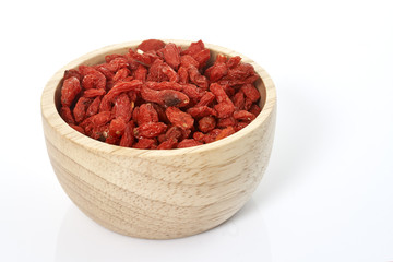 goji berry in wooden cup on white background.