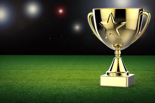 gold star trophy with soccer field background