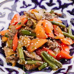 Uzbek salad made of grilled cut vegetables and meat .Uzbek cuisi