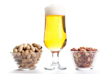 pint of lager and peanuts on white background