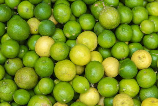 Stack of limes on display at farmers market