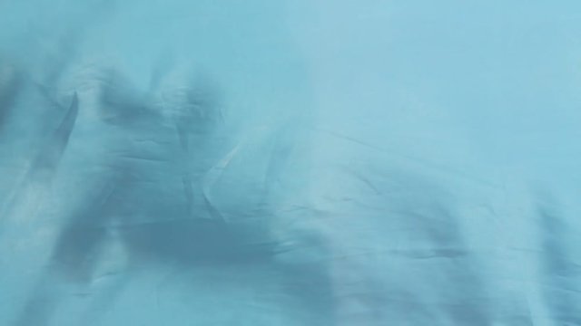 Blue cloth lye swaying in the wind, closeup