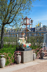 Fototapeta na wymiar vivid green summer view to Chinese sculptures in Pushkin, Russia.