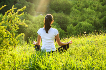 Girl is engaged in meditation on the nature