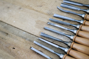 Top view of chisel tools set on wooden surface, closeup flat lay