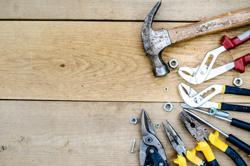 Closeup flat lay of tools on a wooden surface 