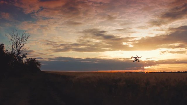 Custom drone hexacopter flying in the sky at sunset