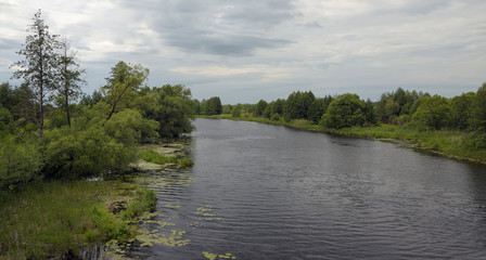 Fototapeta na wymiar Cloudy landscape with river