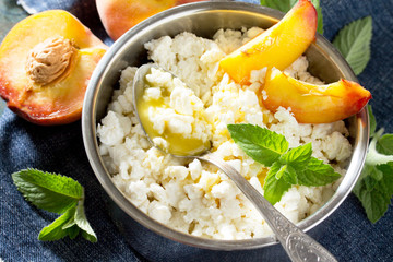 Homemade cheese, honey and fresh peaches, healthy food, cooking