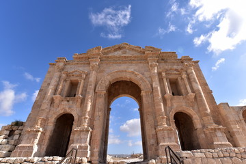 Fototapeta na wymiar Arch of Hadrian in Jerash, Jordan is an 11-metre high triple-arched gateway erected to honor the visit of Roman Emperor Hadrian to the city 