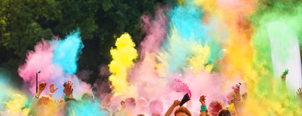 Crowd of people throwing colored powder