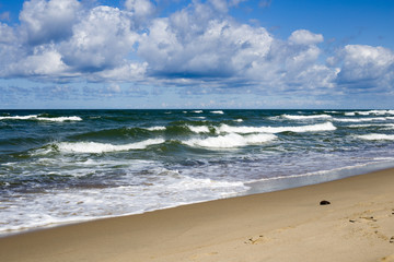 Big waves with foam on sea coast