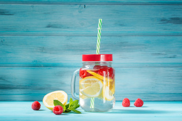 Detox water cocktail with lemon, raspberry and mint