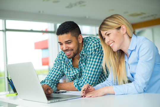 Business couple working at the office looking happy
