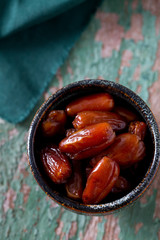 dried dates on a beautiful wooden background