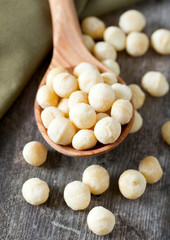 salted macadamia nuts on wooden surface